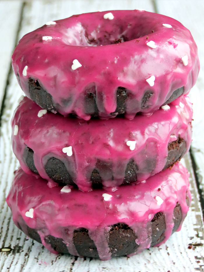 Chocolate Donuts with Pomegranate Glaze stacked on each other