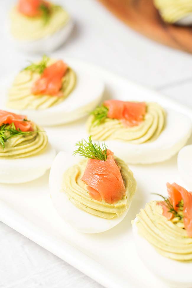 These Avocado Deviled Eggs are topped with smoked salmon and garnished with dill! | yummyaddiction.com