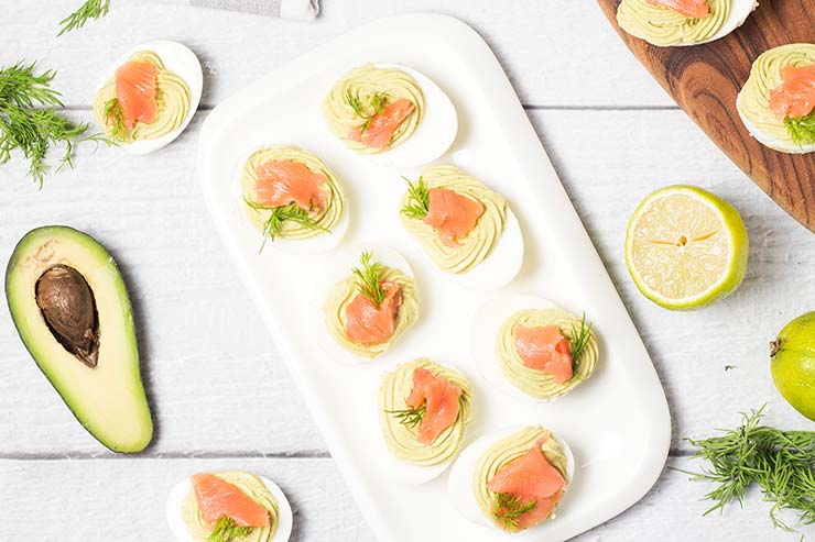 These Avocado Deviled Eggs are topped with smoked salmon and garnished with dill! | yummyaddiction.com