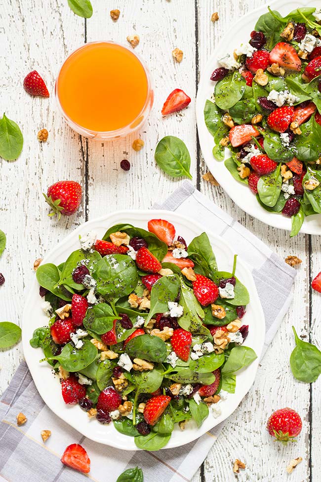 This Strawberry Walnut Salad features spinach, blue cheese, cranberries, and is topped with a fantastic poppy seed dressing. Perfect for summer! | yummyaddiction.com