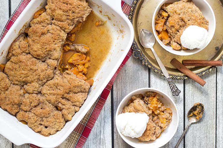 This Sweet Potato Cobbler is full of cinnamon, nutmeg and cloves flavor. Topped with a buttery crust and served with a dollop of ice cream on top! | yummyaddiction.com