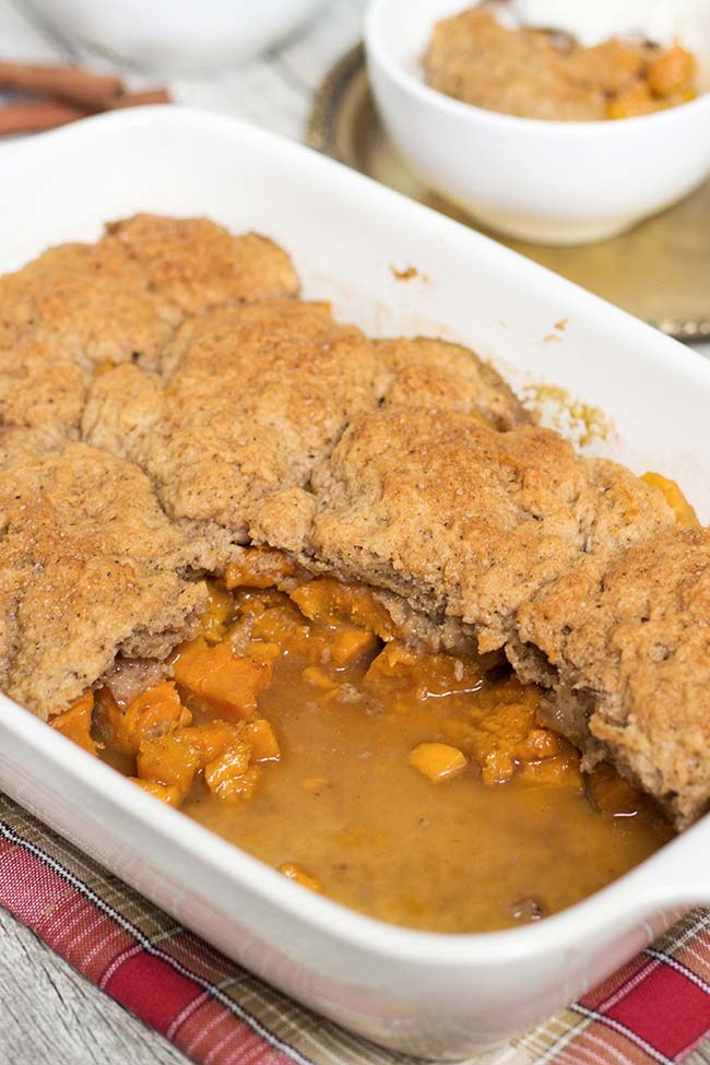 This Sweet Potato Cobbler is full of cinnamon, nutmeg and cloves flavor. Topped with a buttery crust and served with a dollop of ice cream on top! | yummyaddiction.com