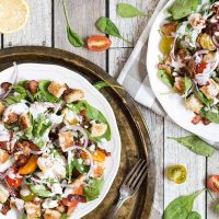 This Spinach Bacon Salad with a buttermilk blue cheese dressing is perfect for a light lunch. It also features tomatoes and croutons that make it even more filling and delicious! | yummyaddiction.com