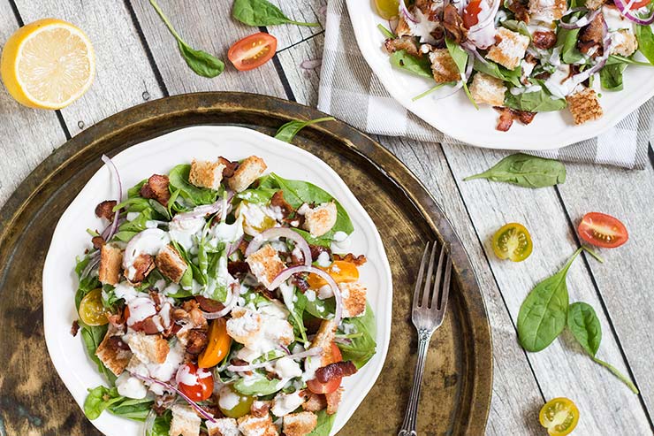 This Spinach Bacon Salad with a buttermilk blue cheese dressing is perfect for a light lunch. It also features tomatoes and croutons that make it even more filling and delicious! | yummyaddiction.com