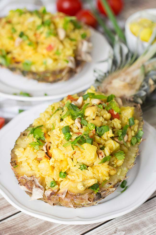 This Thai Pineapple Fried Rice with chicken makes a perfect weeknight dinner. It's delicious and healthy. Served in pineapple shells, it's also great for parties or other occasions! | yummyaddiction.com