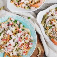 This Seafood Pasta Salad is comforting, hearty, and filling. It features pasta, imitation crabmeat, shrimp, and veggies together with a mayo or yogurt dressing! | yummyaddiction.com