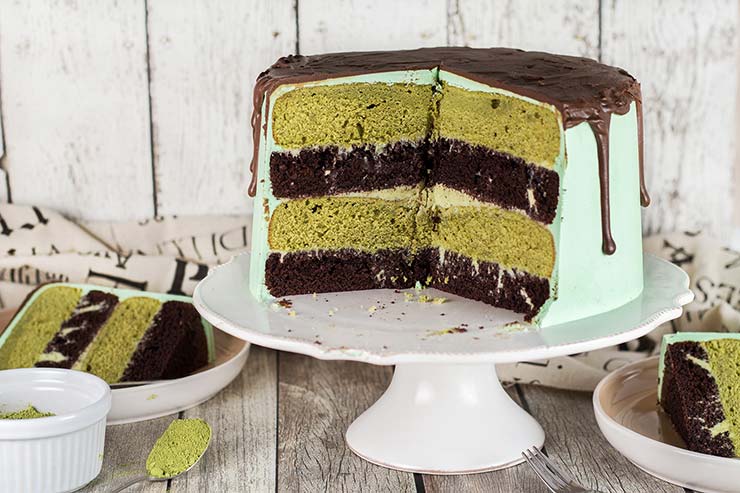 This Green Tea Cake featuring chocolate and matcha cake layers slathered with matcha white chocolate ganache, frosted with vanilla buttercream, and topped with chocolate glaze is a dream! | yummyaddiction.com