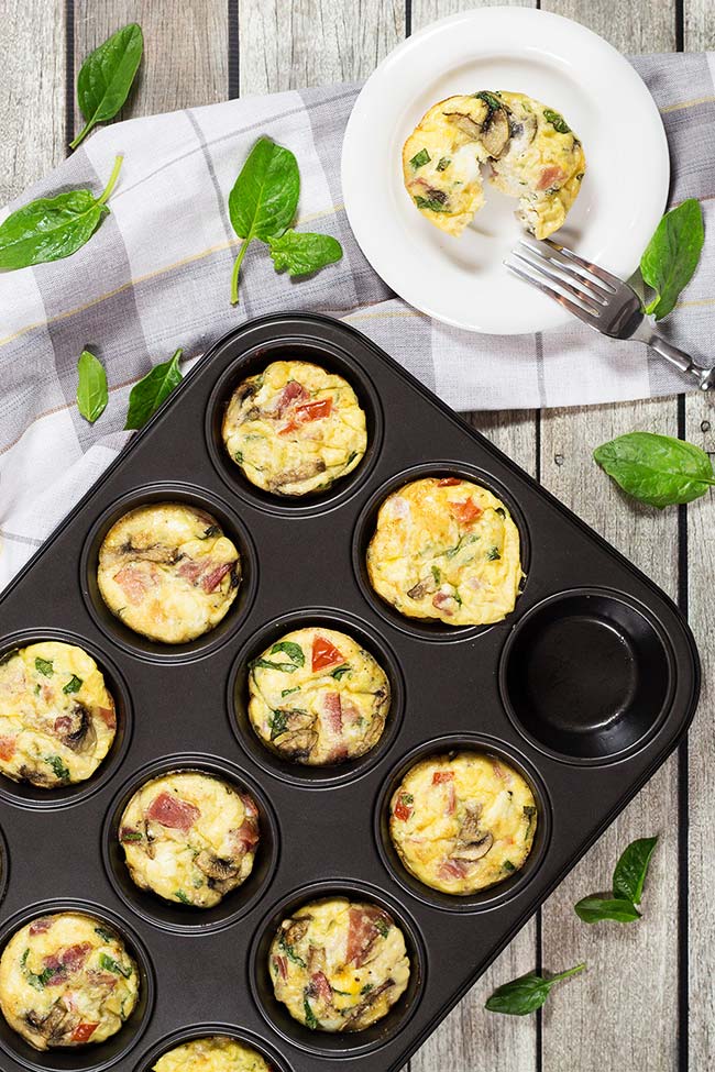 Check out these heavenly delicious Muffin Tin Omelets. They are packed with prosciutto, feta, spinach, and mushrooms. A perfect make-ahead breakfast! | yummyaddiction.com
