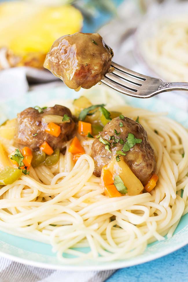 These Sweet and Sour Meatballs with Pineapple flavored and carrot and bell pepper packed sauce, make a great full meal or an appetizer. Comforting, tender, delicious! | yummyaddiction.com