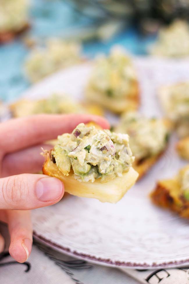 Have you ever tried serving Avocado Chicken Salad on Pineapple Slices? A great appetizer for any occasion your friends and family will absolutely love! | yummyaddiction.com