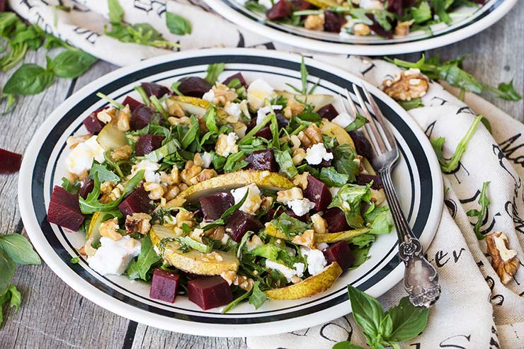 This Cold Beet Salad features goat cheese, pear, arugula, walnuts, basil, and a fantastic honey-balsamic-basil dressing. Great as a side dish or a light standalone meal! | yummyaddiction.com