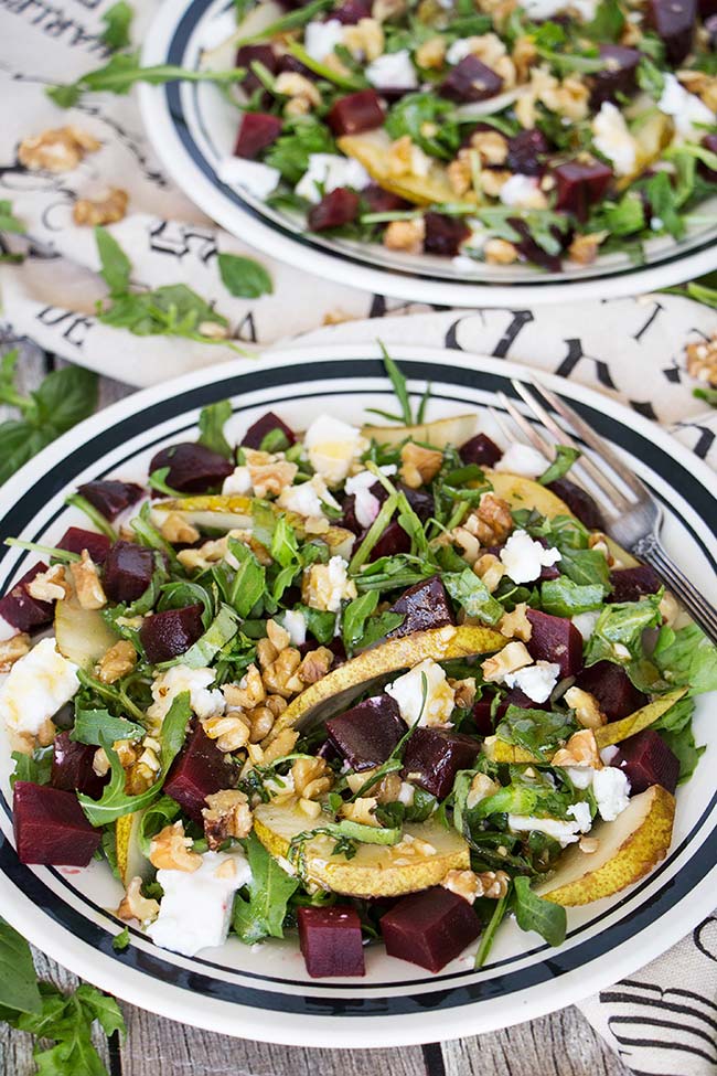 This Cold Beet Salad features goat cheese, pear, arugula, walnuts, basil, and a fantastic honey-balsamic-basil dressing. Great as a side dish or a light standalone meal! | yummyaddiction.com