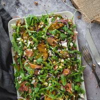 overhead of arugula pear salad