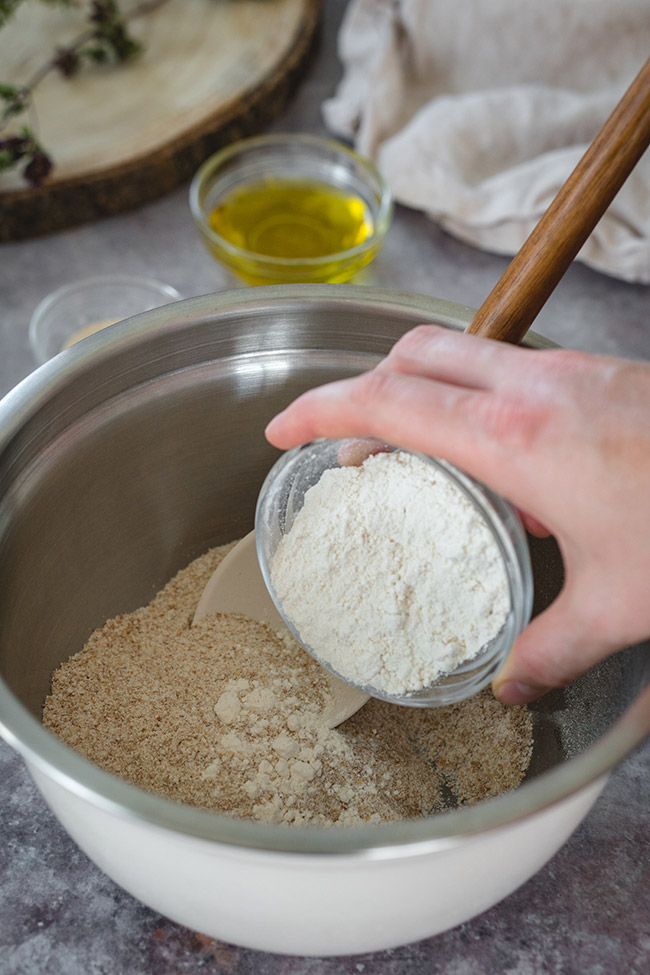 Adding flour to the pizza dough