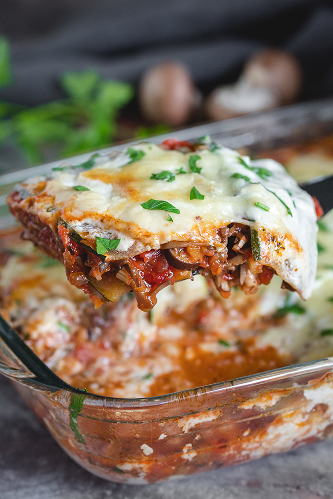 Serving a piece of easy mushroom lasagna with zucchini