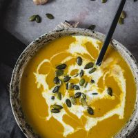 Bowl of pumpkin ginger soup with spoon