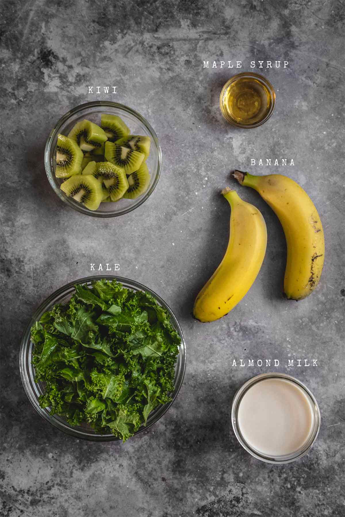 Ingredients of kiwi kale smoothie bowl on a table