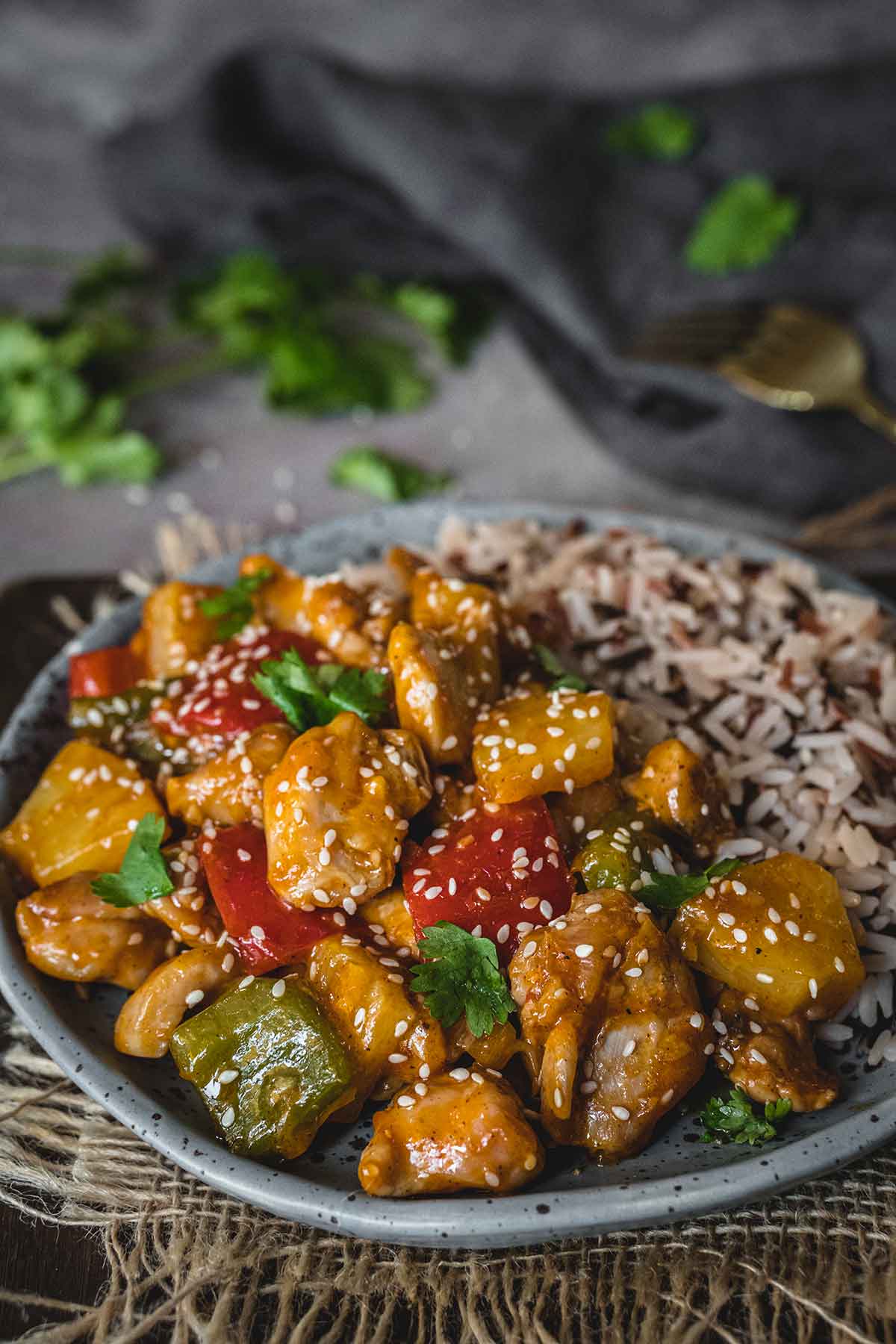 Chinese pineapple chicken served with rice on a plate