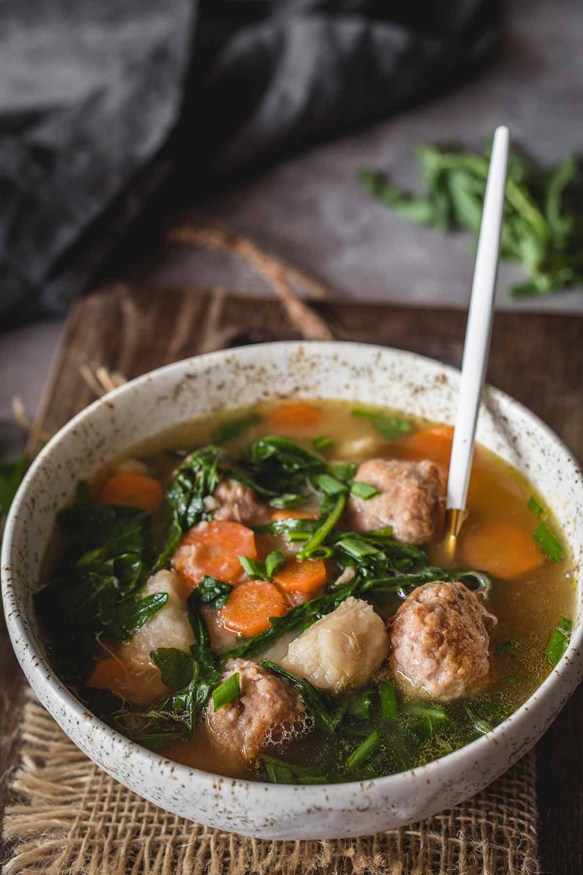 Cozy taro soup with arugula and turkey meatballs in chicken stock