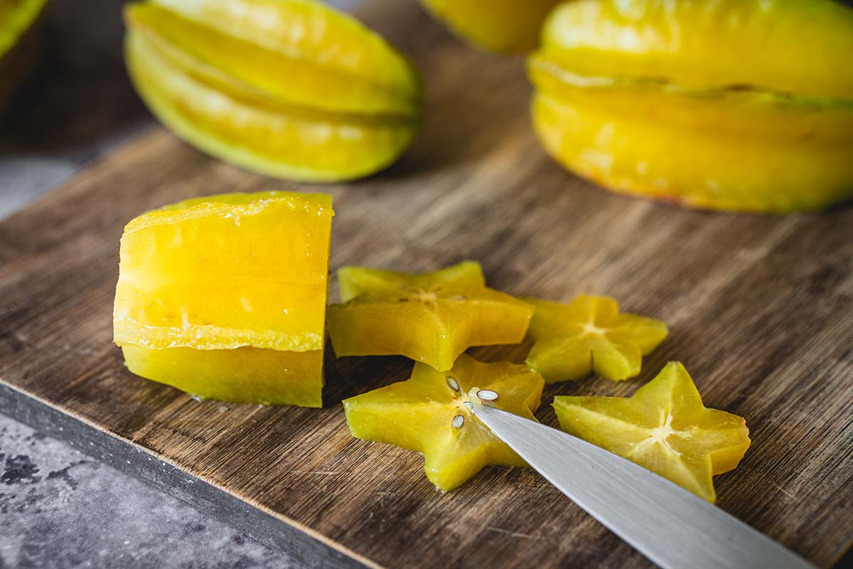 Removing the seeds with a knife of the star fruit