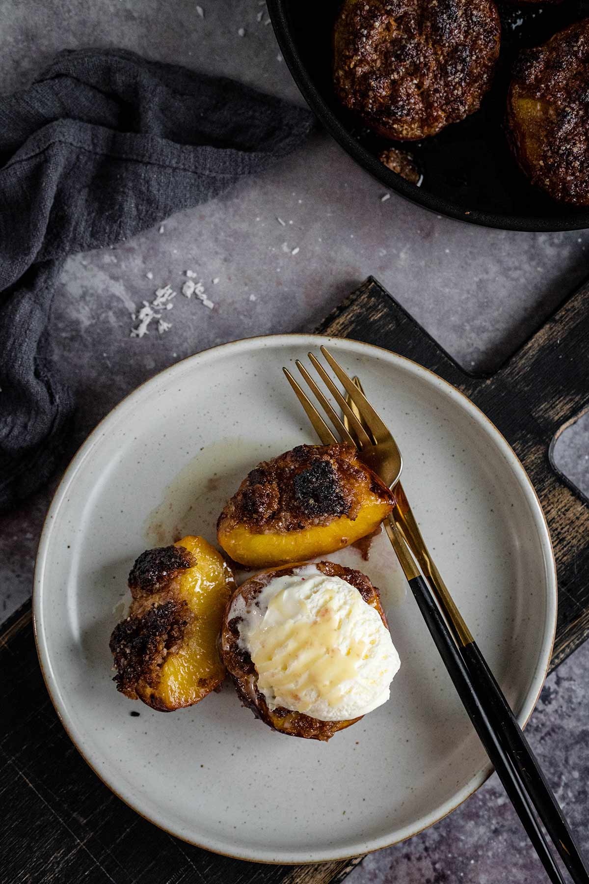 Grilled peaches topped with a scoop of ice cream