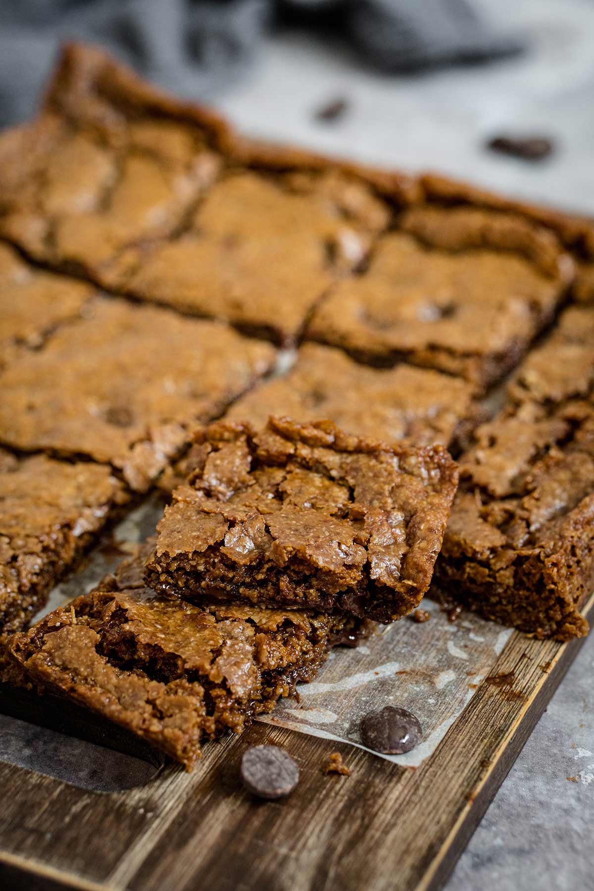 Dairy-free chocolate chip cookie bars on a wooden cutting board