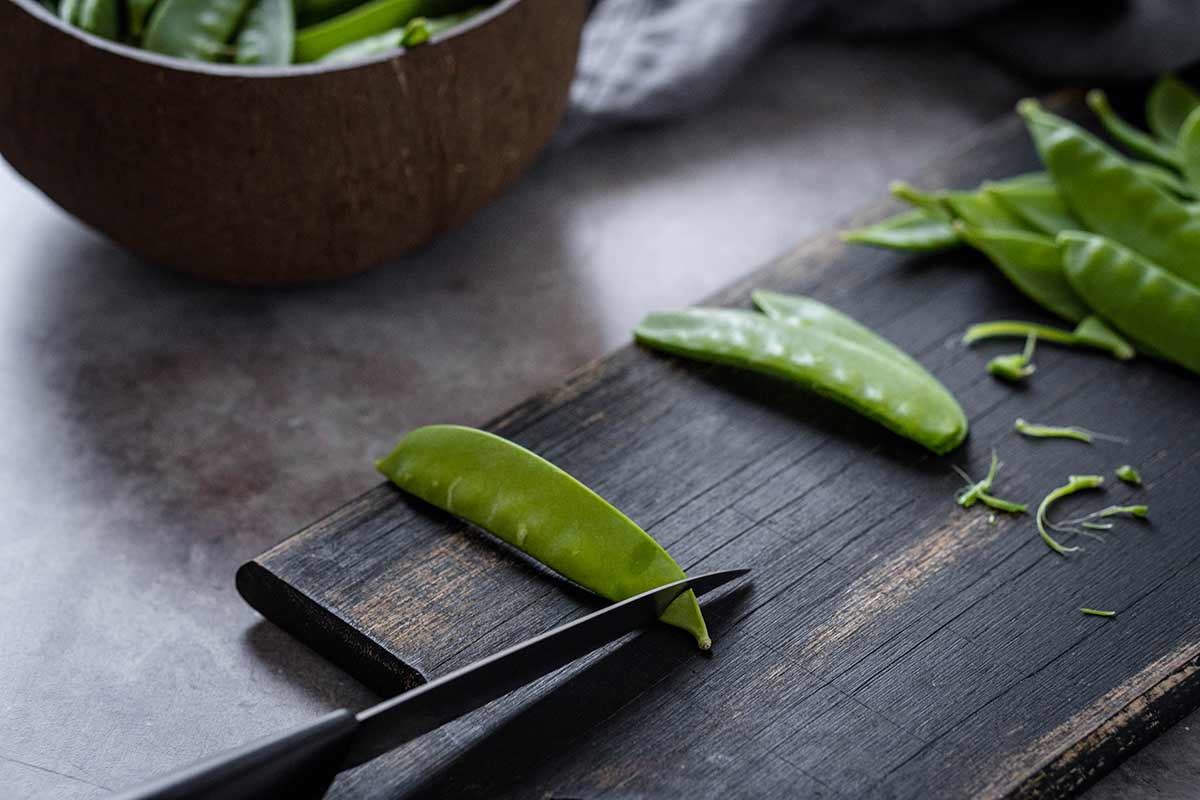 Cutting the ends off snow peas
