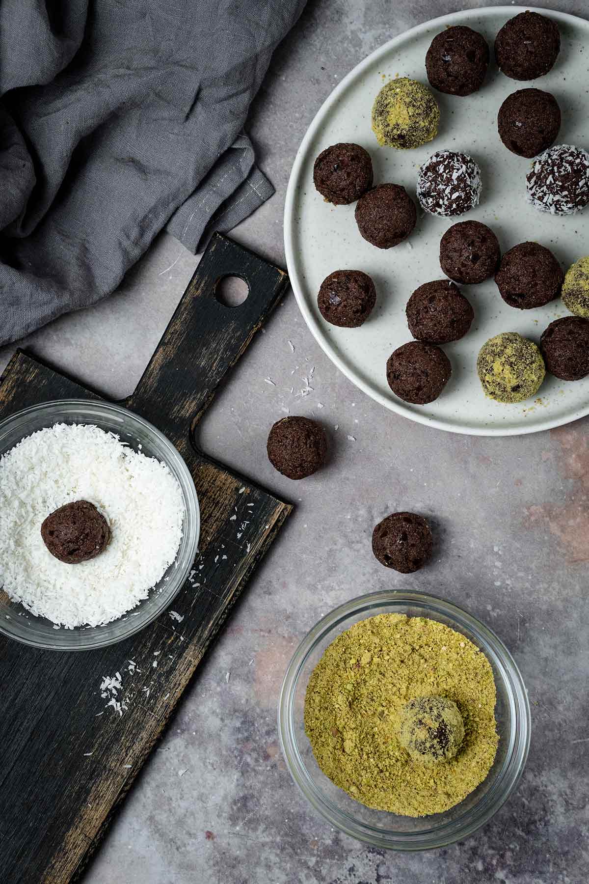 Date energy balls coated with coconut flakes and ground pistachios