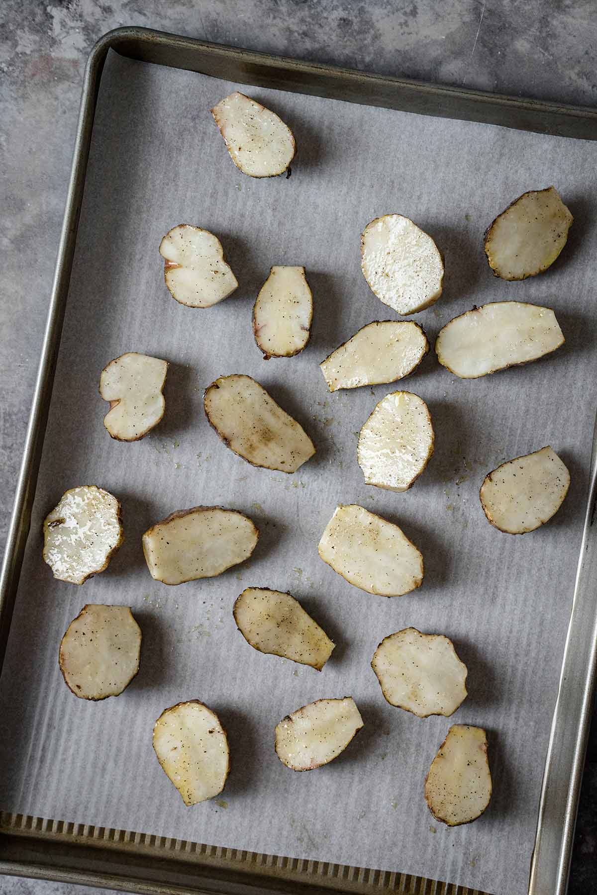 Halved seasoned sunchokes before roasting